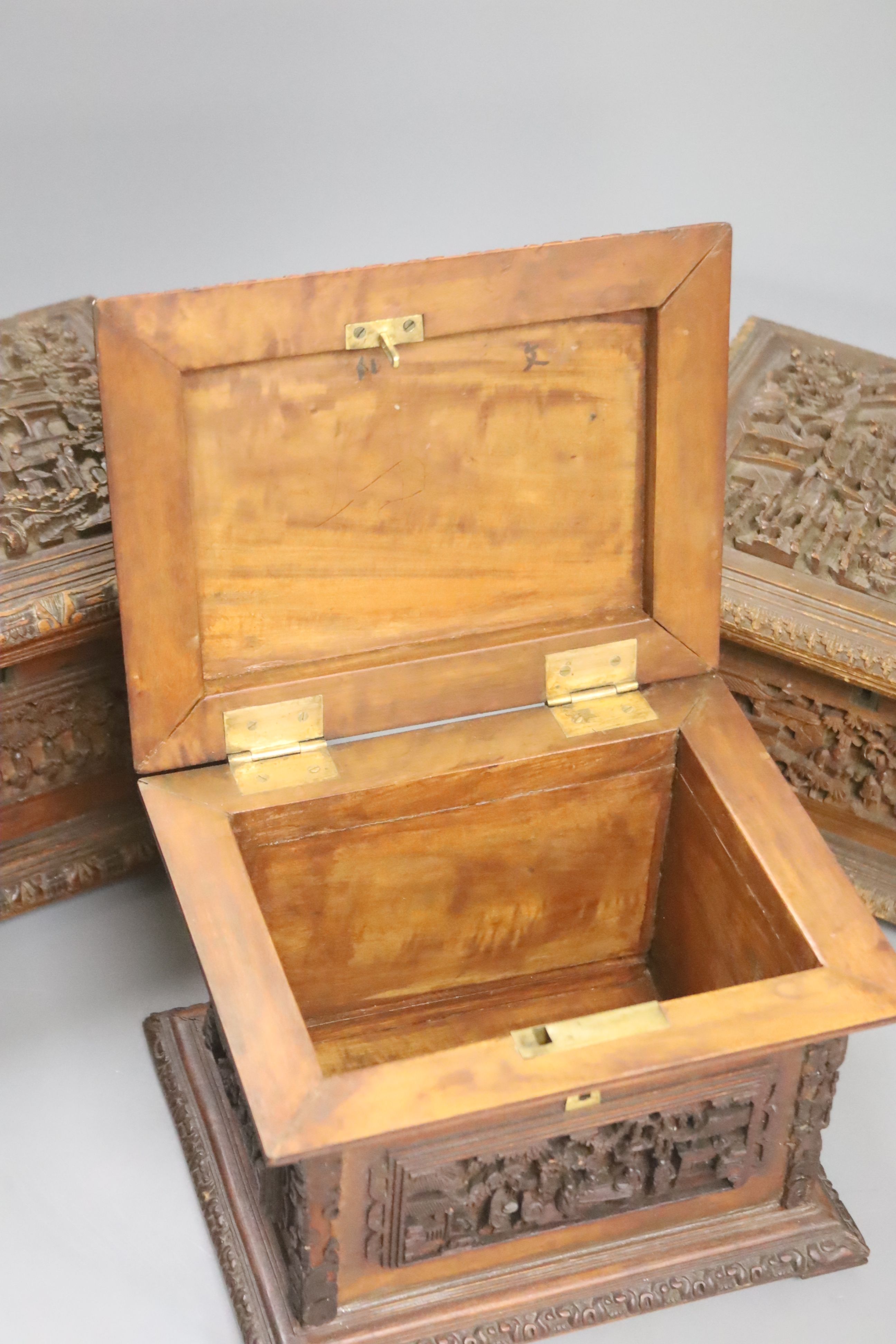 Three Chinese carved hardwood caskets, largest 19 x 15cm 13cm high